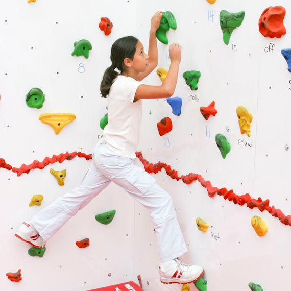 Girl using the Discovery Dry Erase Climbing Wall 8'