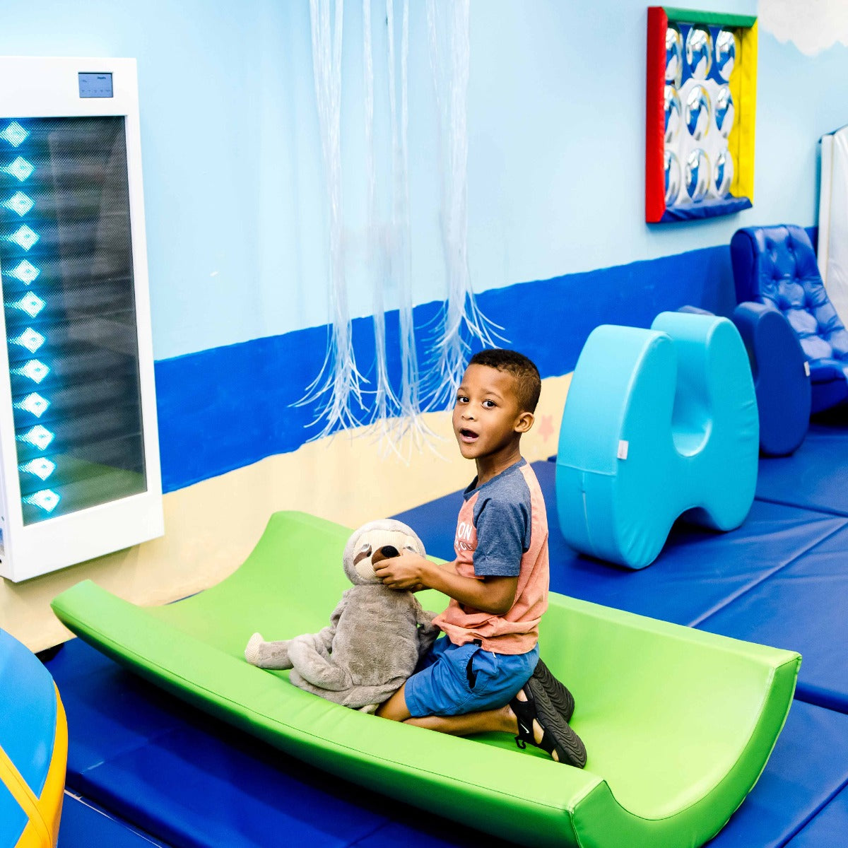 Boy playing in a room with the Activated light up Wall Panel