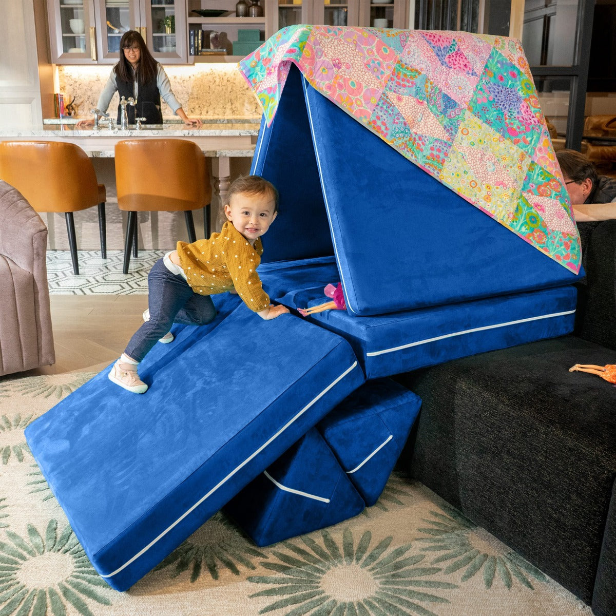 Child playing on the blue Zipline PlayScape Convertible Kids Couch