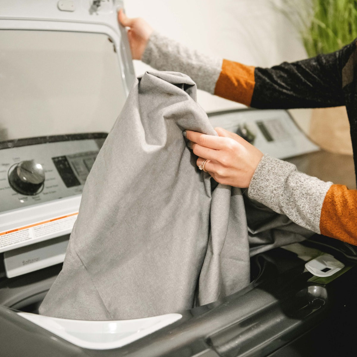 Woman holding the Big Joe Fuf-Medium in the color Lenox Fog