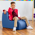 Boy smiling while sitting on the Sensory Wave Chair in the color blue
