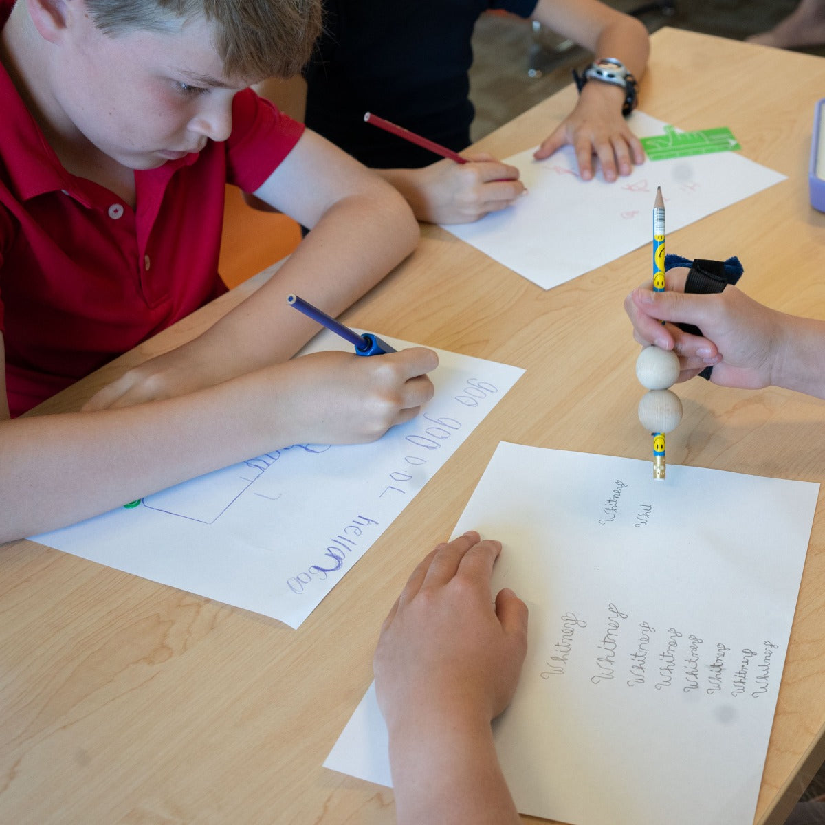 Children using the Pencil Weights while writing