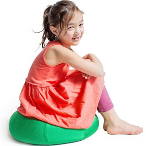 Girl sitting on the green Mushy Smushy Bean Bag Chair