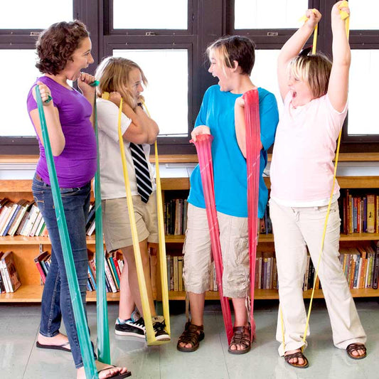 Kids using the CanDo latex-free resistive exercise bands