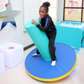 Girl smiling while playing on the SensaSoft™ Rockin Roll Top