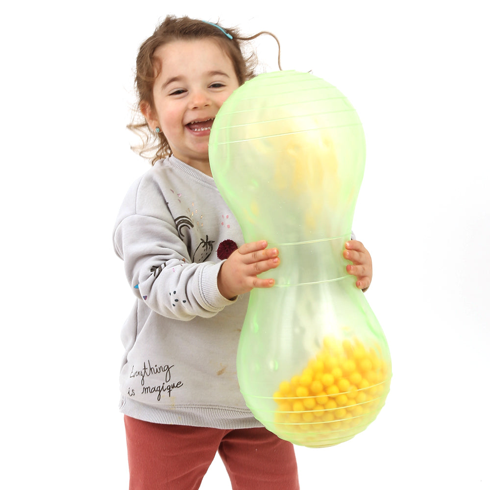 Child smiling while playing with the sensory Rumble Roller