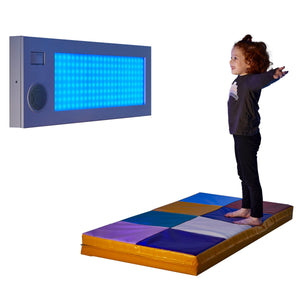 Girl smiling while using the SensaSoft™ Musical Lightup Hopscotch