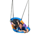boy laying on the Magic Carpet Swing