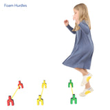 Girl playing with the foam hurdles