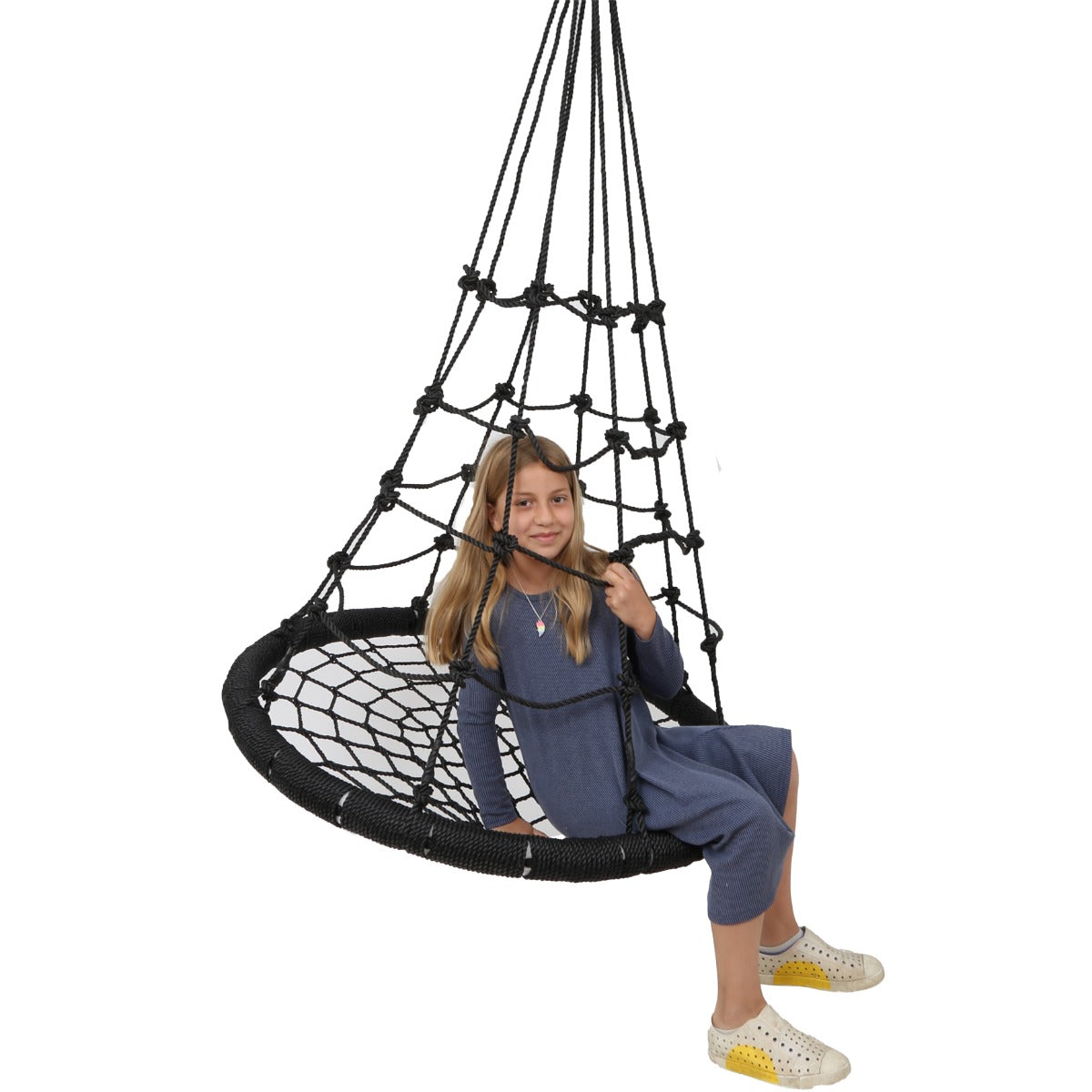 Girl smiling while sitting on the Web Tower Swing