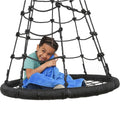 Boy smiling while sitting on the Web Tower Swing