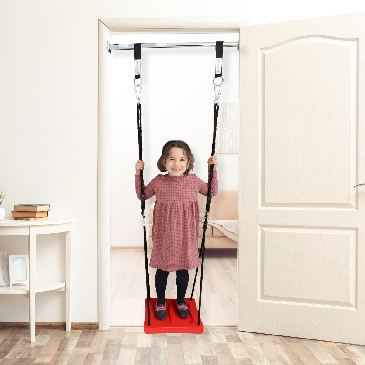 girl using red Standing Swing suspended from doorway