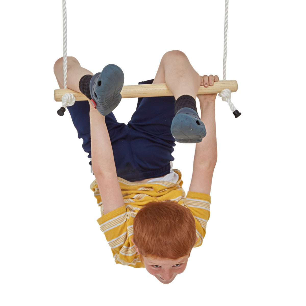 Child hanging upside down from the bottom bar of a double trapeze bar swing