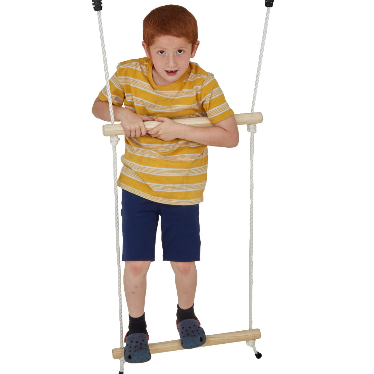 child standing upright and swinging on a double trapeze bar swing