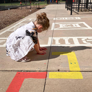child playing with the Outdoor Paint-A-Path