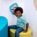 Child sitting near the Swirling Storm Panel