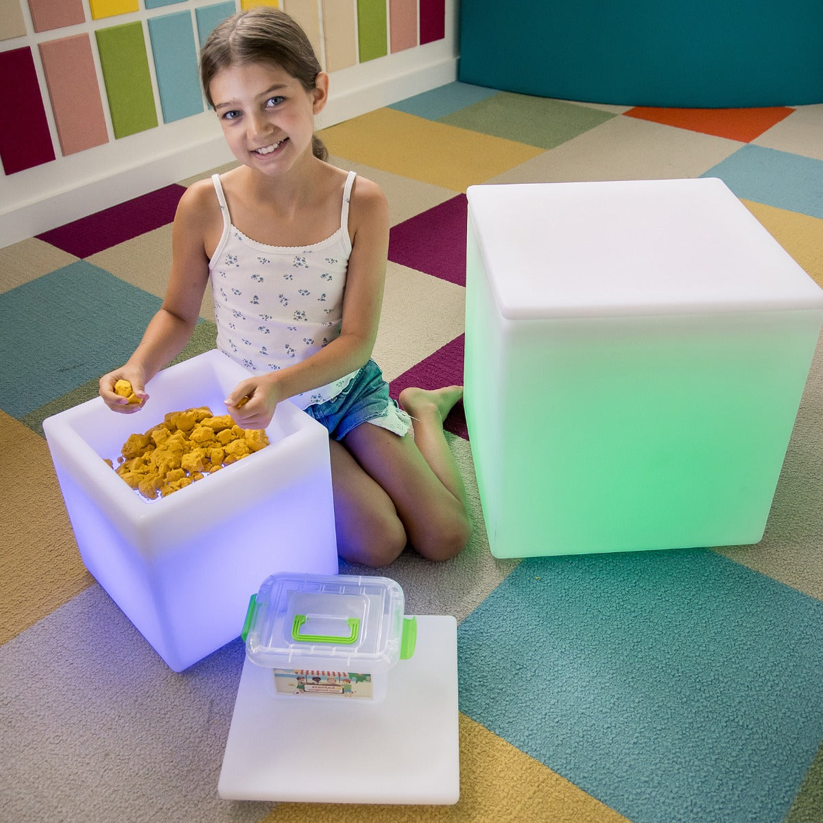 Girl playing with the LimeLite™ LED Sand Table