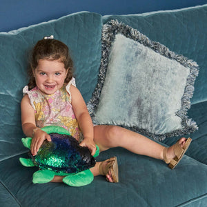 Girl playing with the Weighted Shimmery Turtle