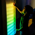 Boy using the Sound Activated light up Wall Panel