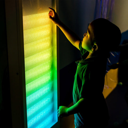 Boy using the Sound Activated light up Wall Panel