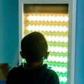 Boy using the Sound Activated light up Wall Panel