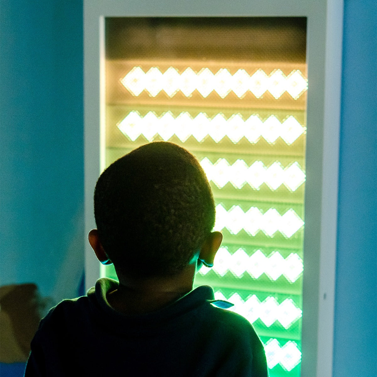 Boy using the Sound Activated light up Wall Panel