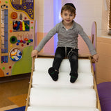 Boy smiling at the top of the LED Sensory Roller Slide
