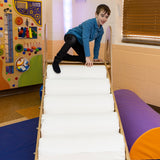 Boy smiling while using the LED Sensory Roller Slide