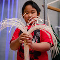 Boy playing with the Fiber Optic LED Strands With Lightsource