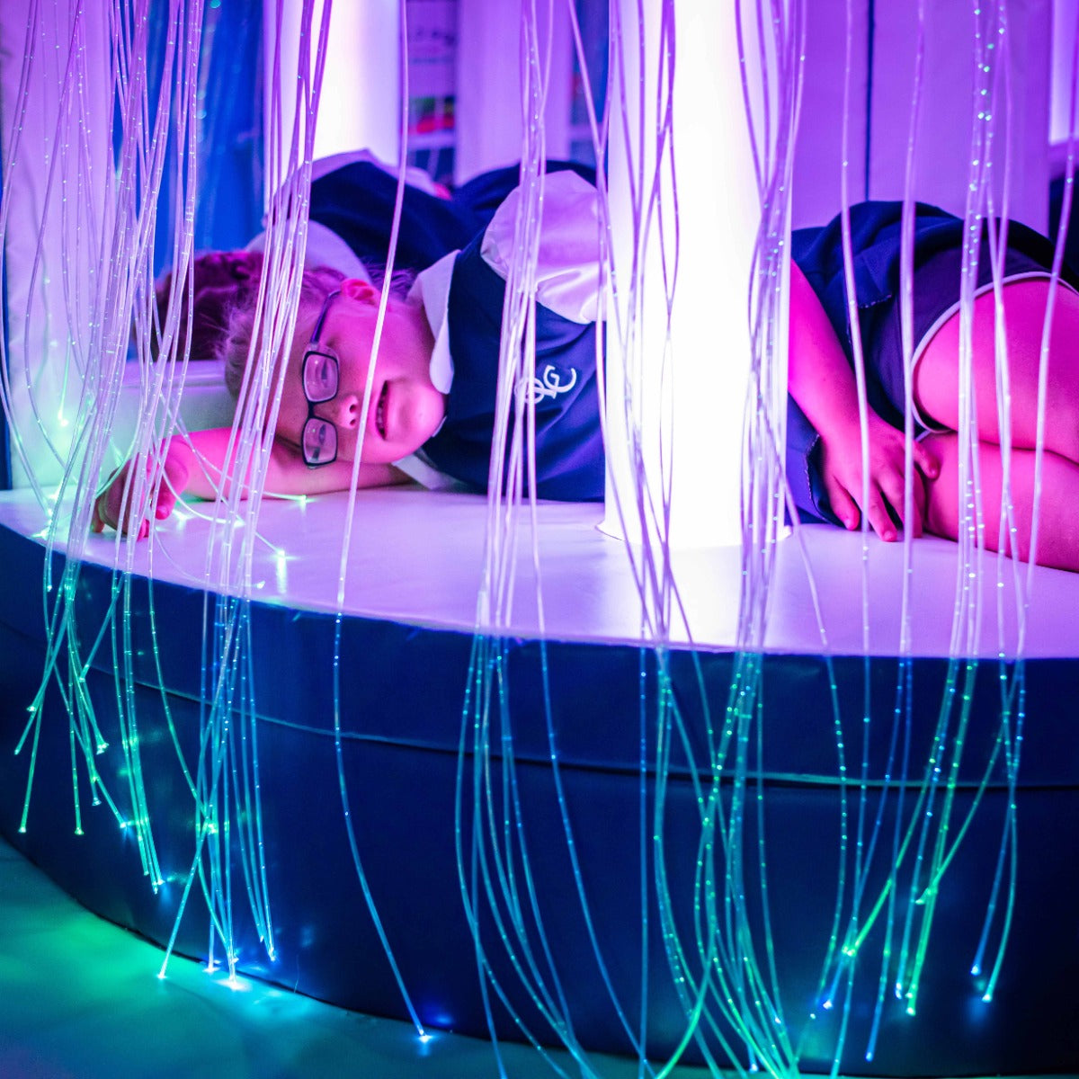 Child playing with the Fiber Optic LED Strands With Lightsource