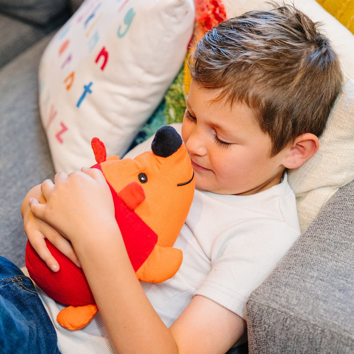 Child holding Hank the Baby Hedgehog - Weighted Plushie