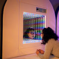 Girl looking through the Fiber Optic Infinity Light Panel