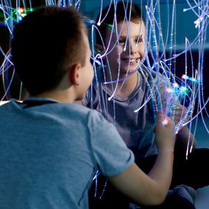 Boy playing with the Fiber Optic Mirror With LED Strands