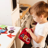 boy playing with the ABC Touch and Feel Letters