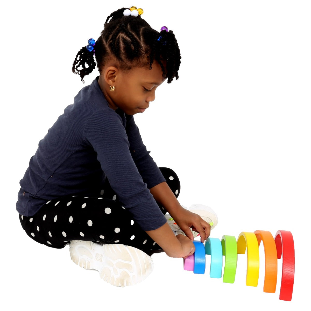 Girl playing with the Rainbow Stacker
