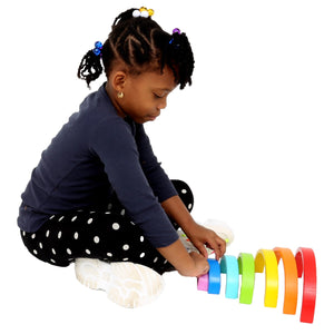Girl playing with the Rainbow Stacker