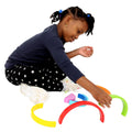 Girl playing with the Rainbow Stacker