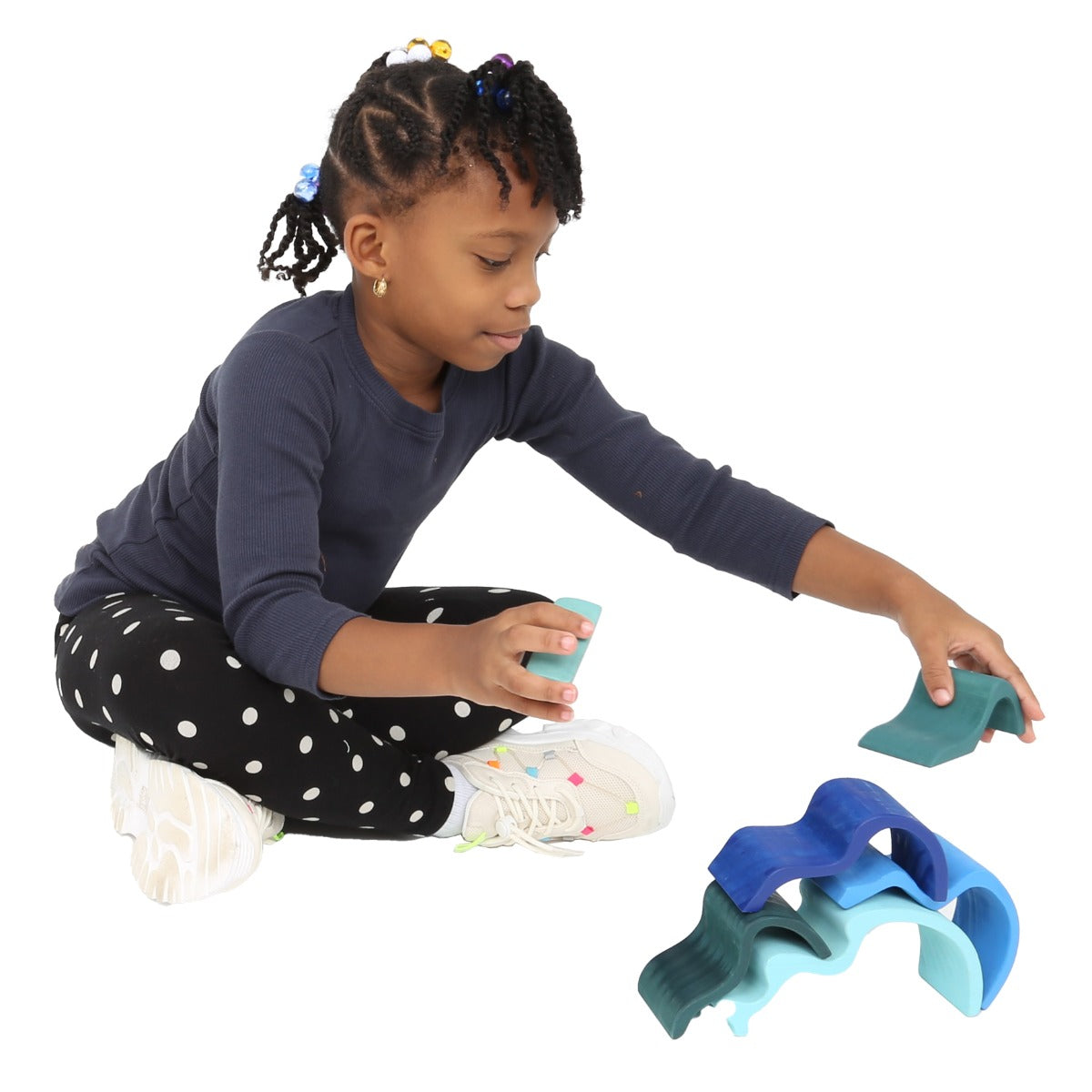 Girl playing with the Wooden Wave Stacker