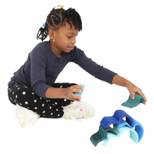 Girl playing with the Wooden Wave Stacker