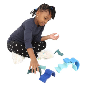 Girl playing with the Wooden Wave Stacker