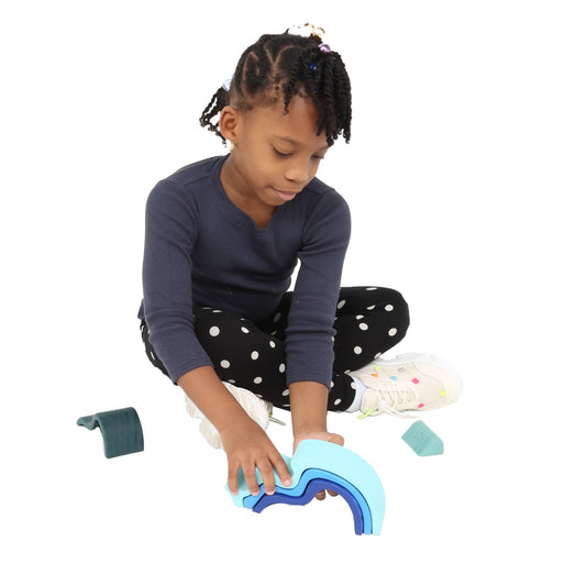 Girl playing with the Wooden Wave Stacker