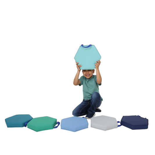 Boy smiling while playing with the Honeycomb Cushions