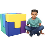 Boy smiling while sitting next to the SensaSoft Puzzle Cube
