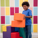 Boy smiling while playing with the SensaSoft Puzzle Cubes