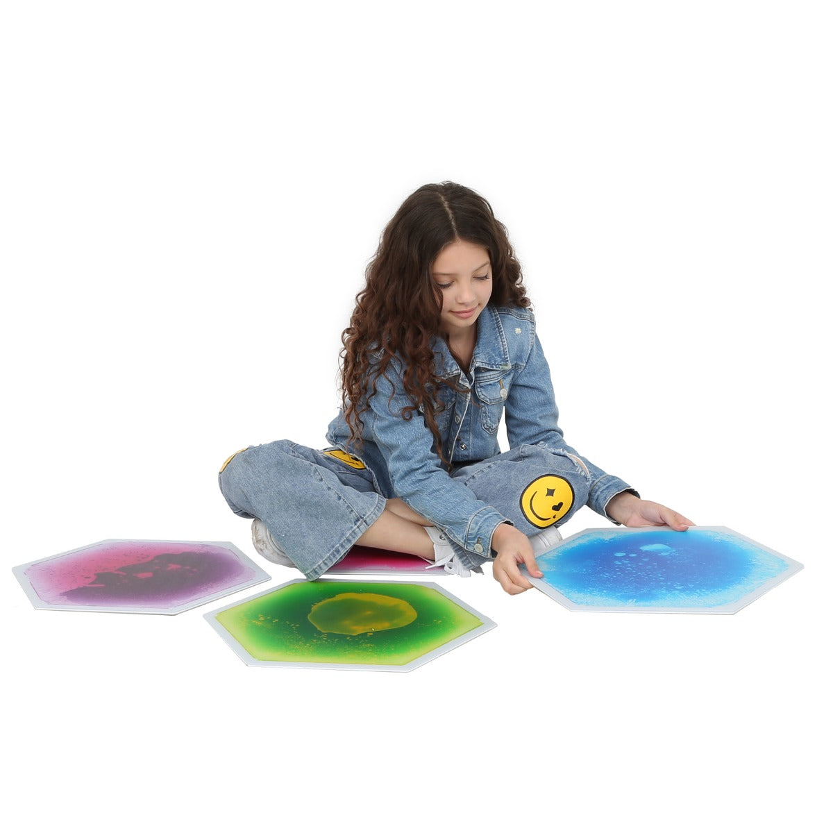 child playing with textured gel tiles