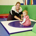 Mother helping child using the SensaSoft Sit 'N Spin for sensory play