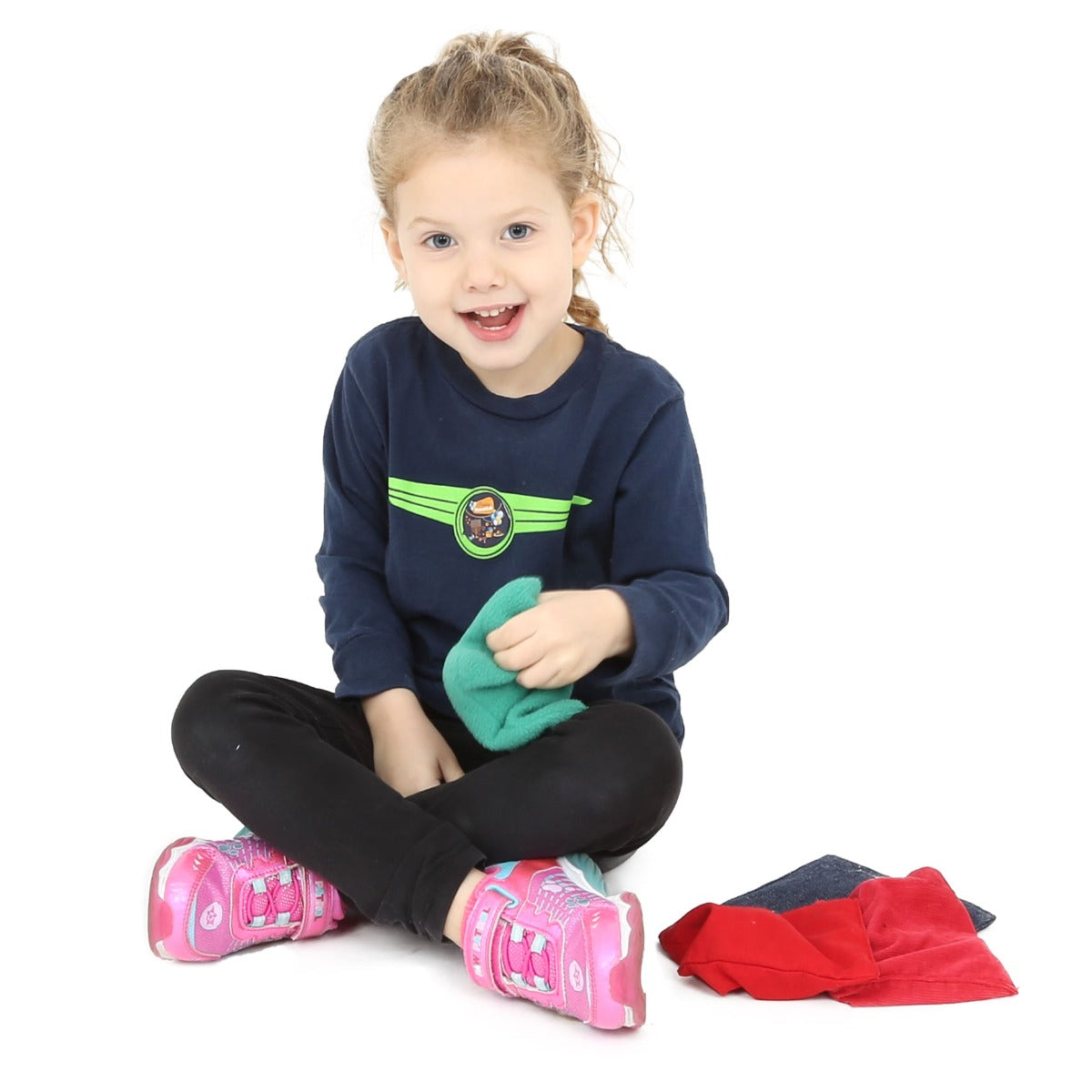 Child smiling while holding the Weighted Tactile Beanbag