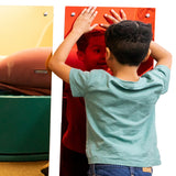 Boy smiling and touching the Tinted Rainbow Mirror