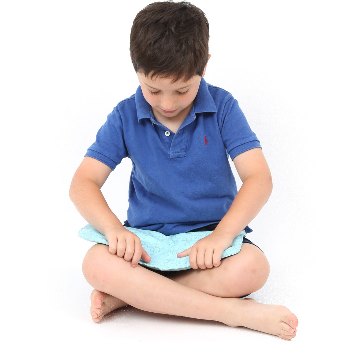 Boy holding the Wipe Clean! Weighted Lap Pad