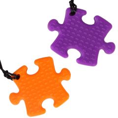 boy and girl smiling while wearing the Puzzle Piece Chewy necklaces